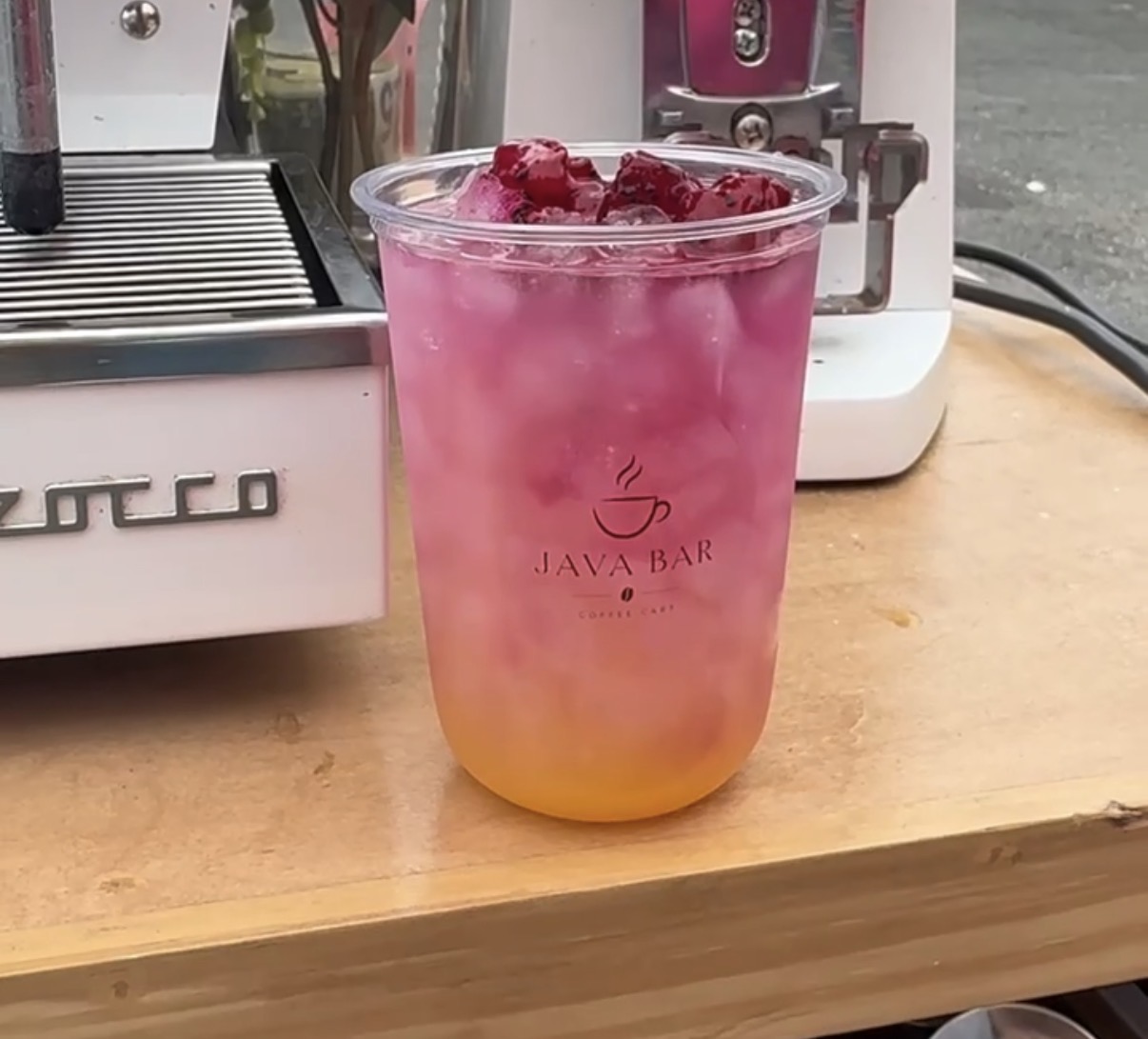 A layered pink refresher in a Java Bar cup