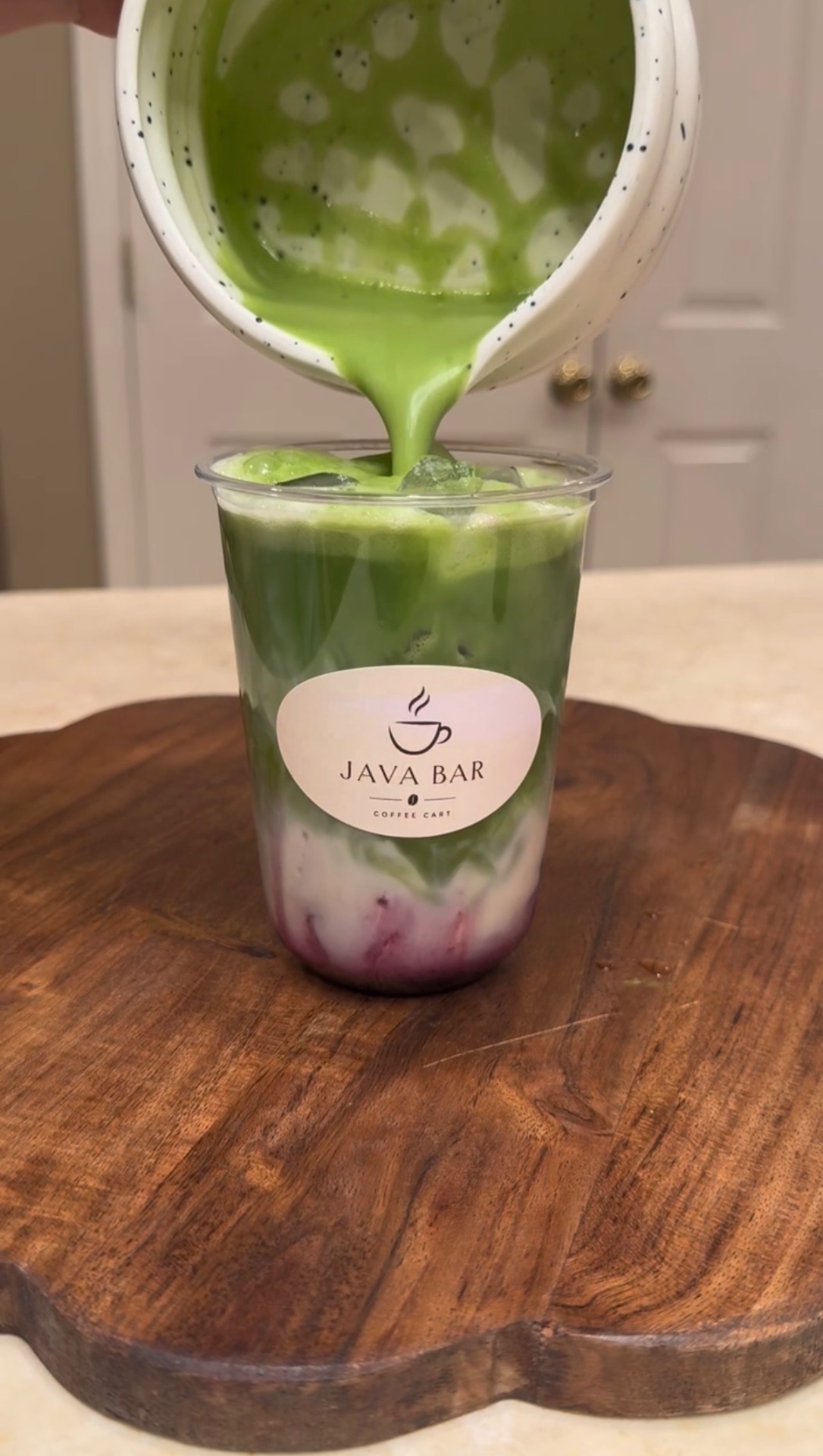 Iced strawberry matcha latte in a Java Bar cup
